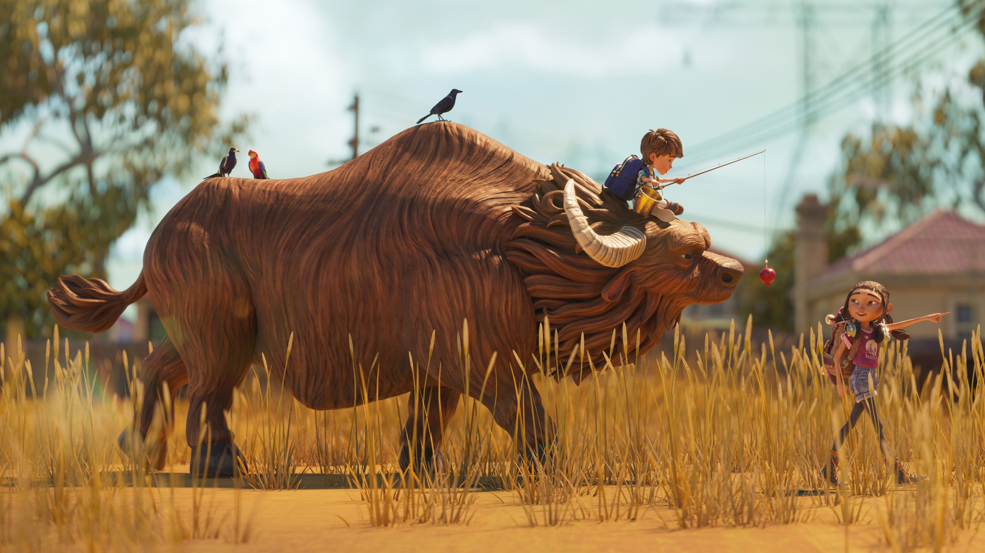 A young boy sits atop a large, stylized, furry creature resembling a buffalo, while holding a fishing rod with a bait dangling. Nearby, a girl gestures towards him, smiling, as birds perch on the creature's back. The scene is set in a grassy area with distant buildings and trees under a clear blue sky.